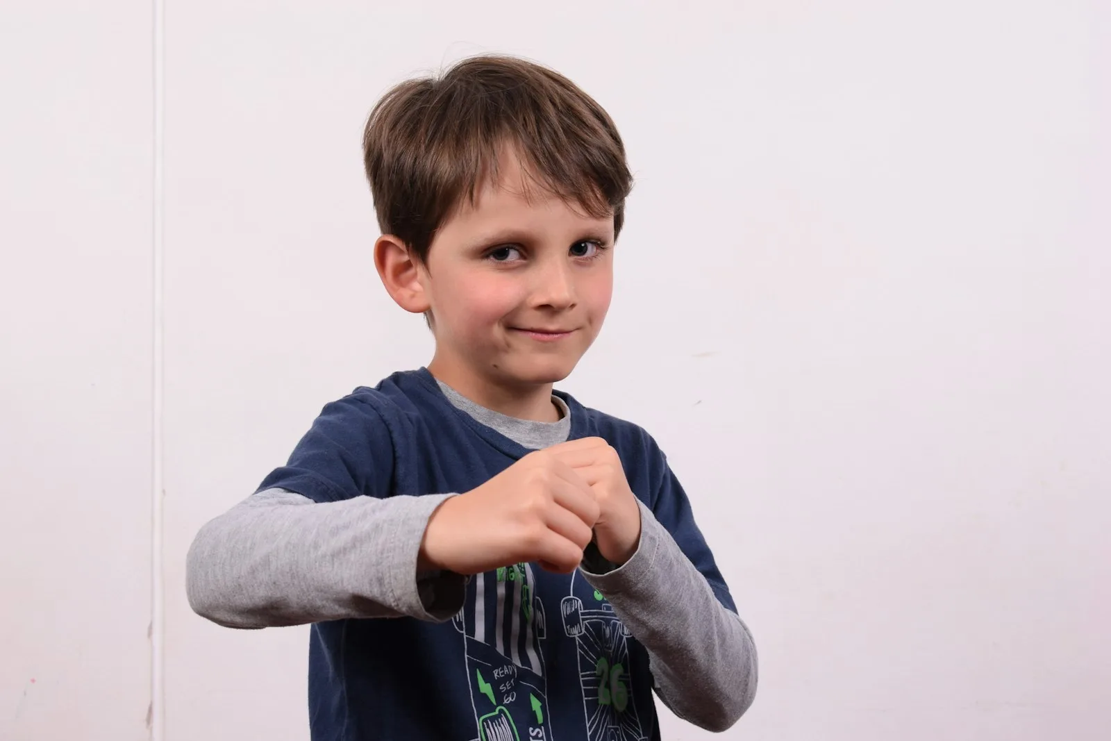 a young boy holding a toothbrush in his hand