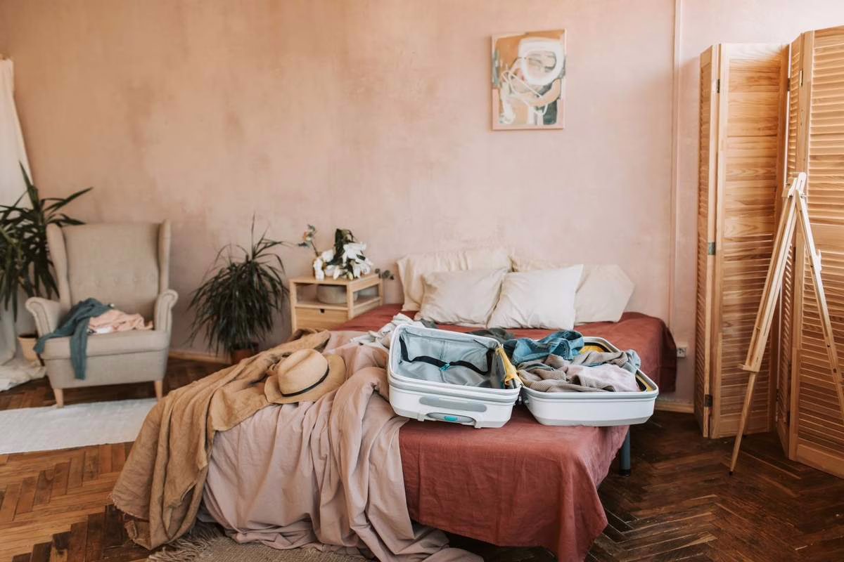 Valise ouverte sur un lit dans une chambre, au retour de vacances